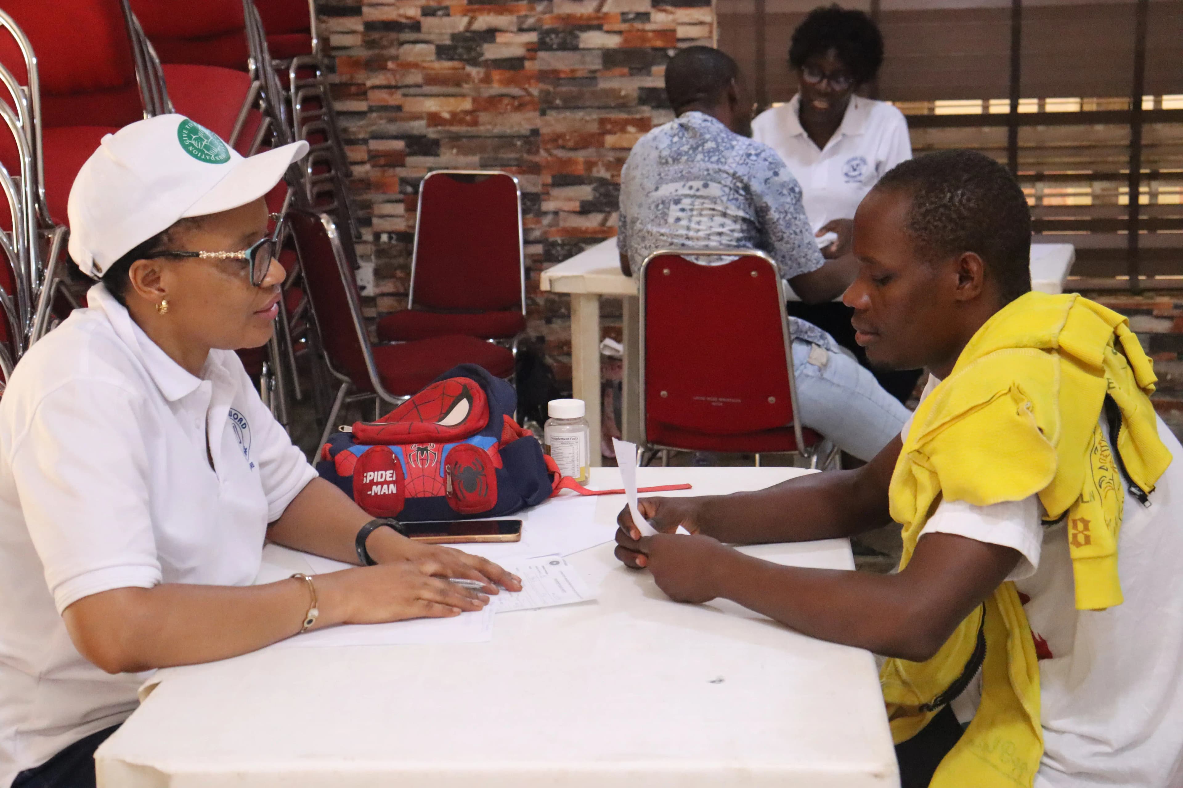 A man and woman sitting across from each other, with the man seemingly talking while the woman is listening