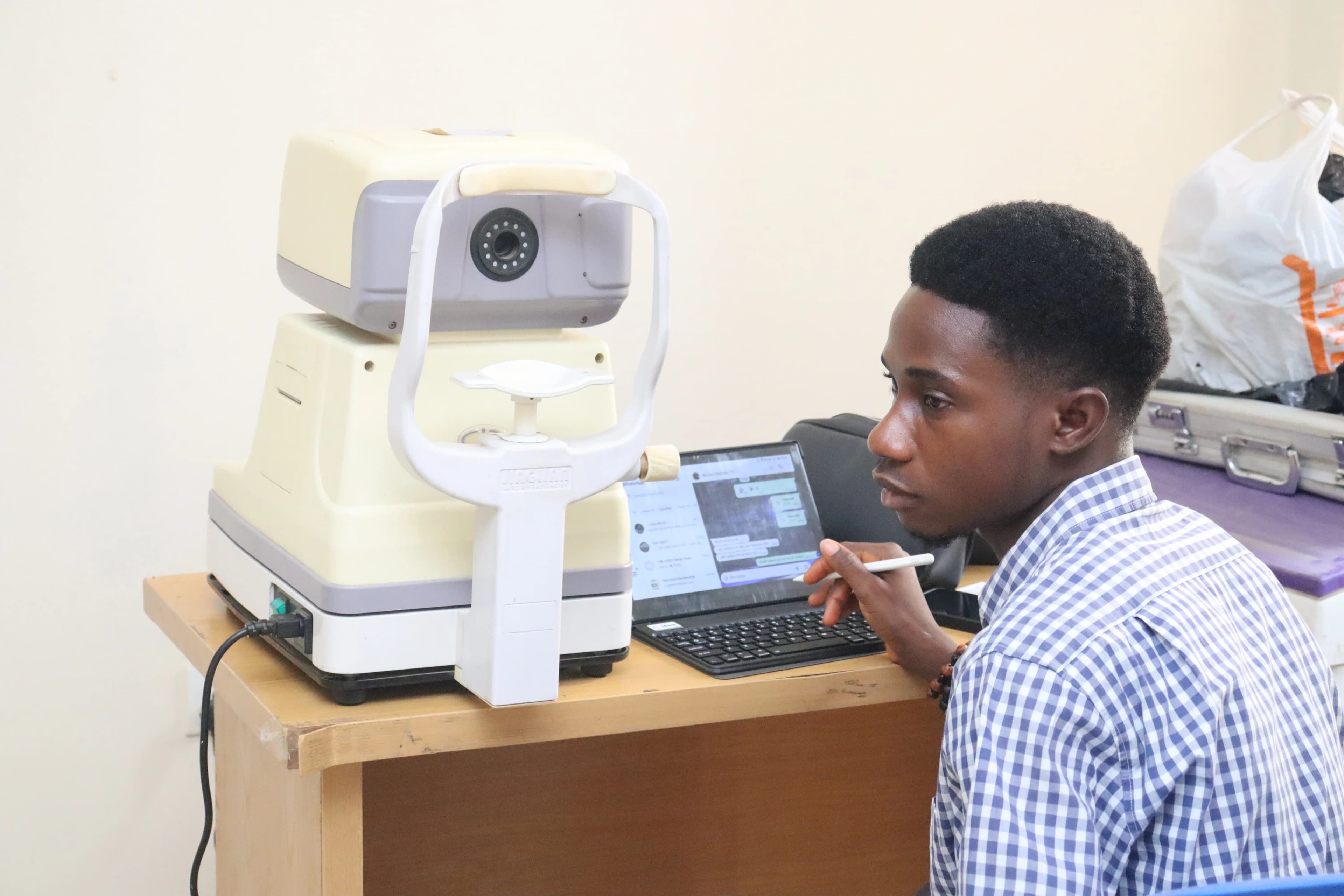 A man sitting in front of an eye machine