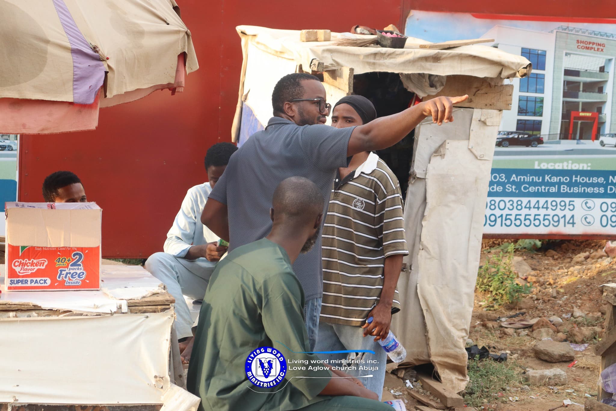 A man talking to and pointing at something afar off